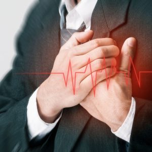 business man clutching his chest from acute pain. Severe heartache, a man suffering from chest pain, having a heart attack or painful cramps, pressing on chest with a painful expression.